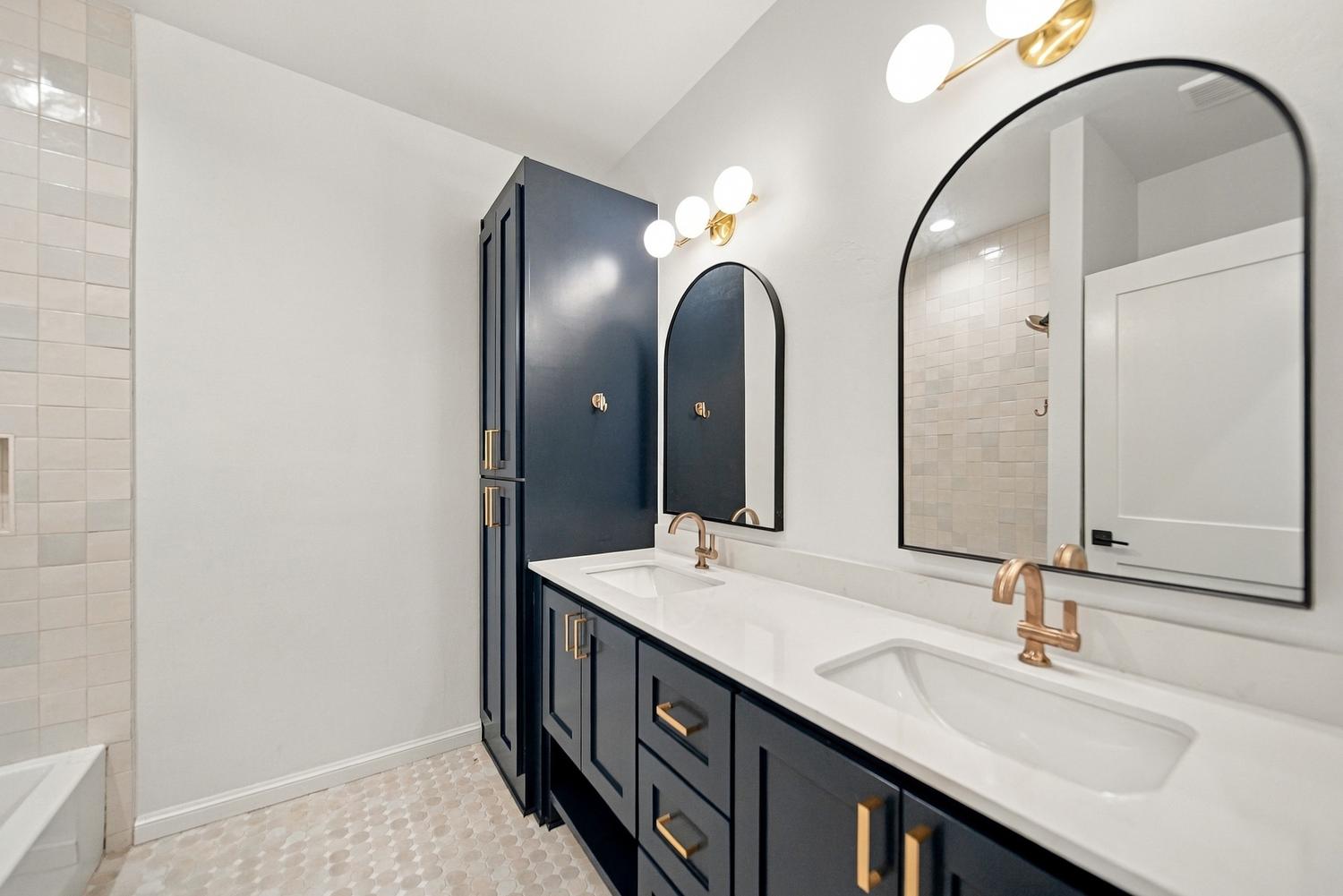 Navy double vanity with arched mirrors